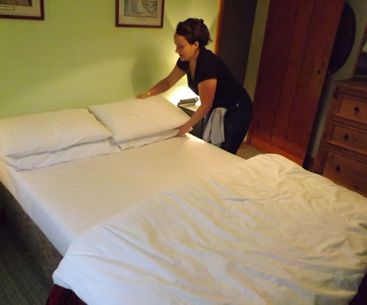 Melanie making a guest bed at Exmoor Cottage Holidays in Exmoor, North Devon